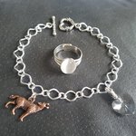 Twilight wolf charm bracelet and moonstone ring worn together showing size and fit on hand