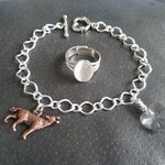 Adjustable silver plated ring with white glass moonstone cabochon showing iridescent opal effect