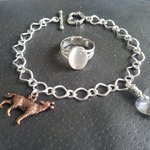 Twilight inspired wolf heart charm bracelet and faux moonstone ring set displayed together on white background